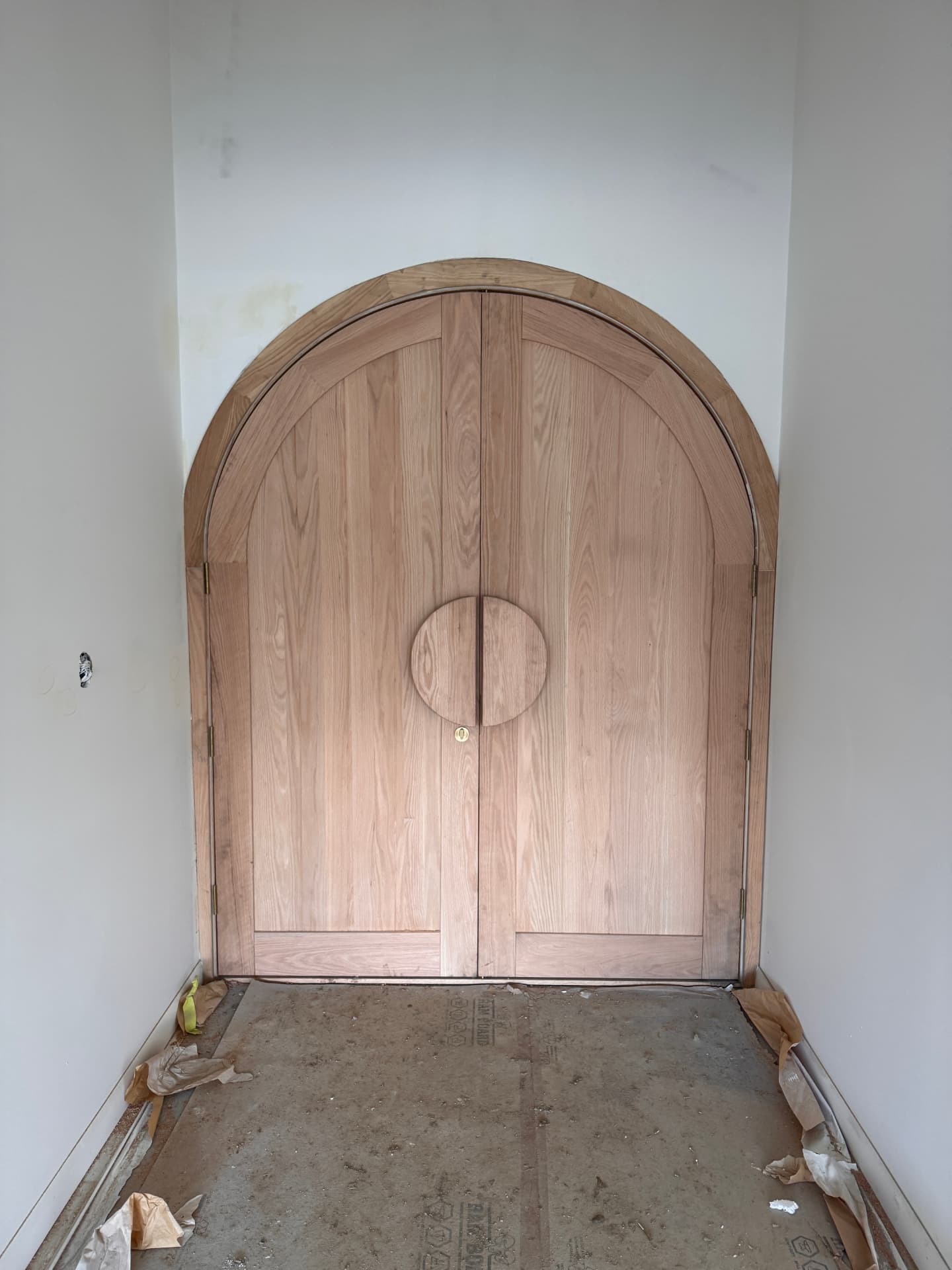 Custom arched timber double entry doors installed in a new home