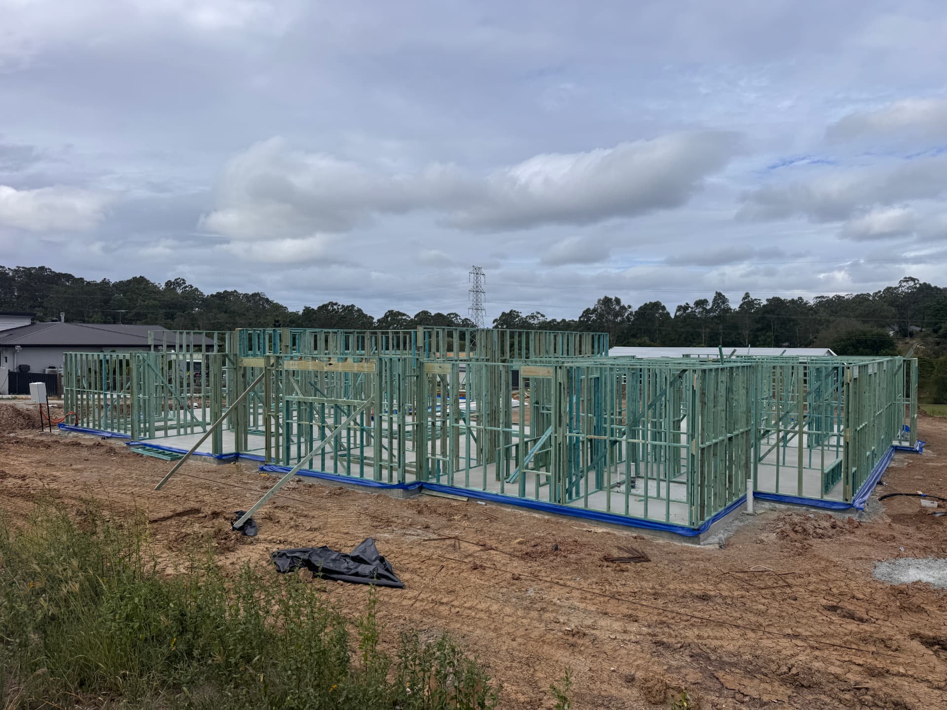 Timber-framed home under construction at dusk